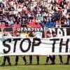 Greek and Serbian football players carry a banner reading 'NATO STOP THE WAR - STOP THE BOMBING' in Belgrade before a friendly match.